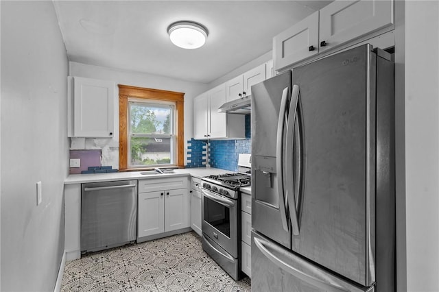 99 Third St, West Warwick, RI 02893 - kitchen with stainless steel appliances, under cabinet range hood, white cabinets, light countertops, and decorative backsplash