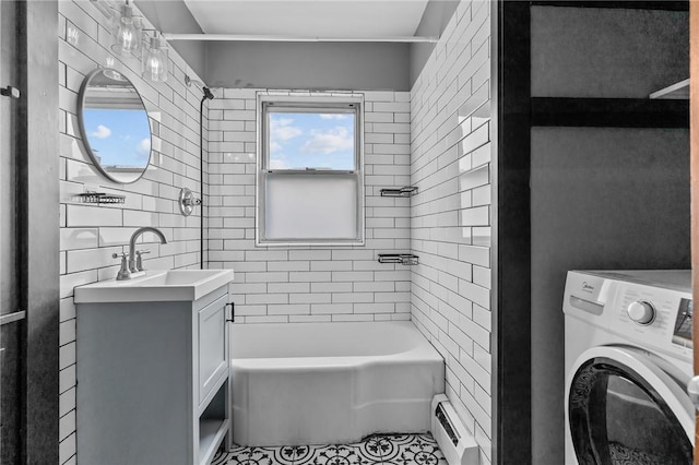 99 Third St, West Warwick, RI 02893 - bathroom featuring washer / dryer, a baseboard heating unit, vanity, tub / shower combination, and tile patterned flooring
