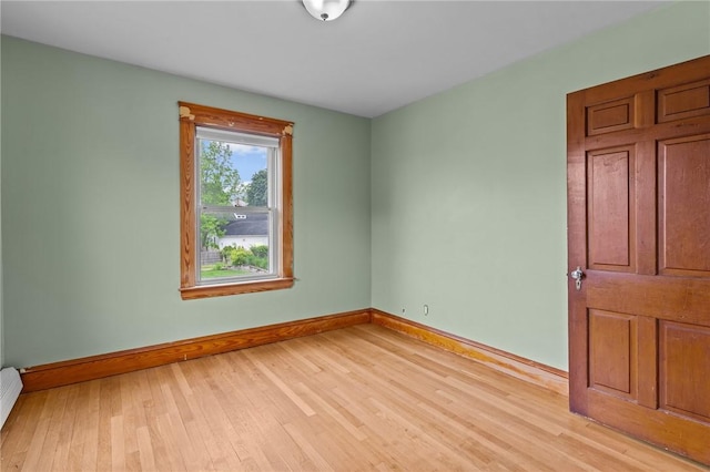 99 Third St, West Warwick, RI 02893 - empty room with baseboards, light wood finished floors, and a baseboard radiator