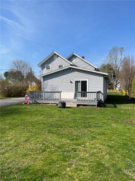 3506 Kingstown Rd, South Kingstown, RI 02892 - view of property exterior featuring a wooden deck and a lawn