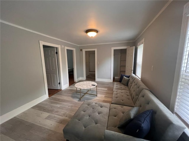 3506 Kingstown Rd, South Kingstown, RI 02892 - living room featuring ornamental molding, healthy amount of natural light, wood finished floors, and baseboards