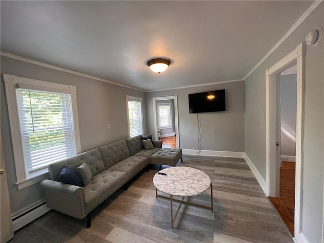 3506 Kingstown Rd, South Kingstown, RI 02892 - living room with a baseboard radiator, wood finished floors, ornamental molding, and baseboards
