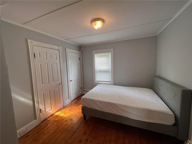 3506 Kingstown Rd, South Kingstown, RI 02892 - bedroom featuring hardwood / wood-style flooring and crown molding