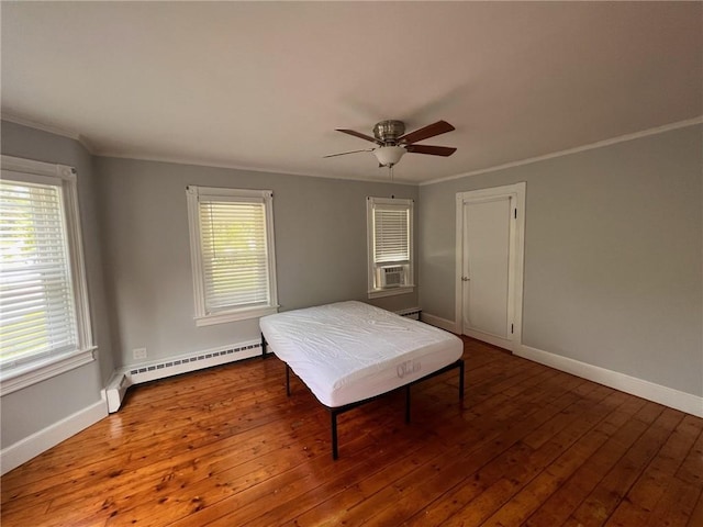 3506 Kingstown Rd, South Kingstown, RI 02892 - bedroom featuring crown molding, a baseboard radiator, hardwood / wood-style flooring, and baseboards