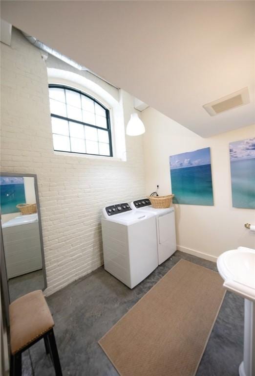 28 Bayley St N Unit 107, Pawtucket, RI 02860 - laundry room with washing machine and dryer, brick wall, and baseboards