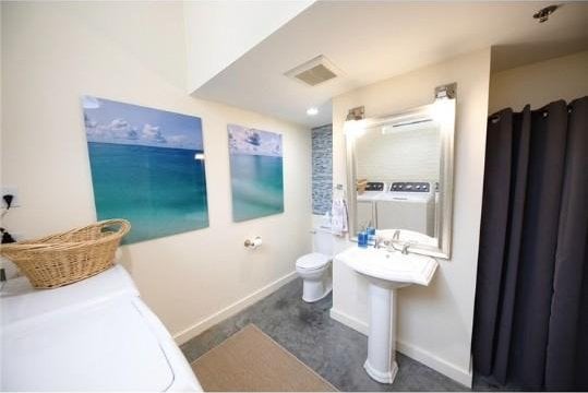 28 Bayley St N Unit 107, Pawtucket, RI 02860 - full bath featuring washer and clothes dryer, toilet, and baseboards