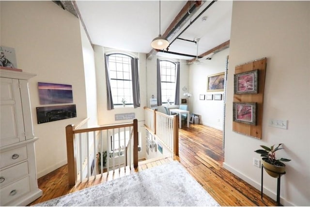 28 Bayley St N Unit 107, Pawtucket, RI 02860 - hall featuring an upstairs landing, wood finished floors, baseboards, and beam ceiling