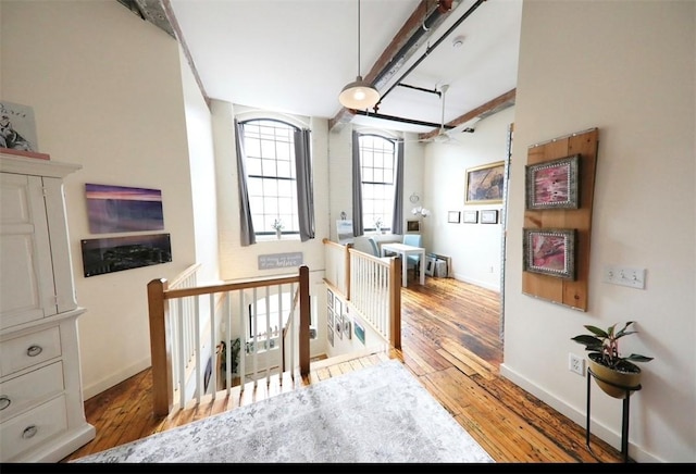 28 Bayley St N Unit 107, Pawtucket, RI 02860 - hallway featuring an upstairs landing, hardwood / wood-style floors, baseboards, and beam ceiling