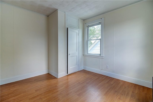 93 Naples Ave, Providence, RI 02908 - empty room featuring light wood finished floors, baseboards, and ornamental molding