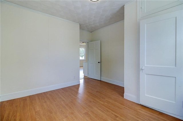 93 Naples Ave, Providence, RI 02908 - empty room with baseboards, light wood finished floors, and crown molding