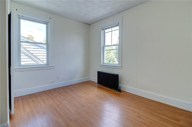 93 Naples Ave, Providence, RI 02908 - unfurnished room with radiator heating unit, light wood finished floors, baseboards, and crown molding