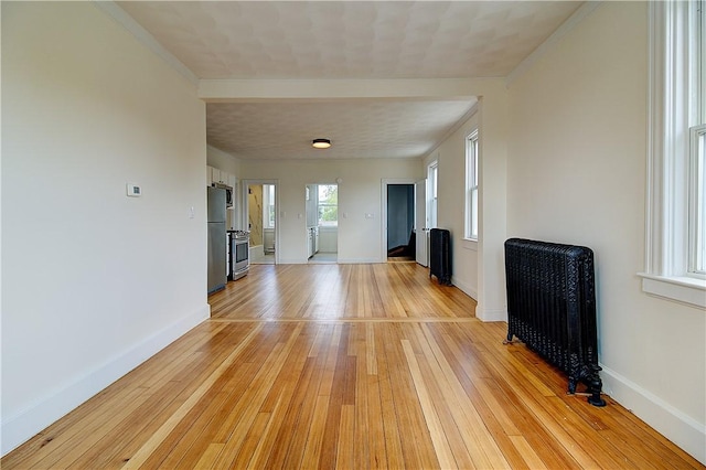 93 Naples Ave, Providence, RI 02908 - unfurnished living room featuring light wood finished floors, baseboards, radiator heating unit, and ornamental molding