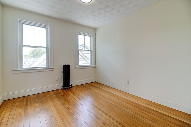 93 Naples Ave, Providence, RI 02908 - spare room with radiator, baseboards, and light wood-type flooring