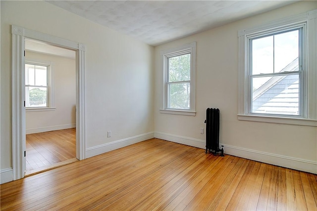 93 Naples Ave, Providence, RI 02908 - unfurnished room featuring radiator, light wood-style floors, and plenty of natural light