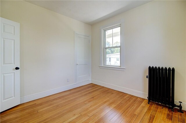93 Naples Ave, Providence, RI 02908 - empty room featuring radiator heating unit, light wood-style flooring, and baseboards