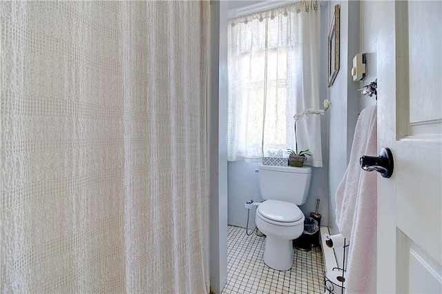 93 Naples Ave, Providence, RI 02908 - full bath with healthy amount of natural light, toilet, and tile patterned floors