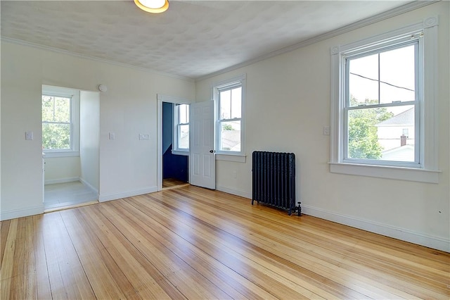 93 Naples Ave, Providence, RI 02908 - spare room with radiator heating unit, plenty of natural light, light wood-style floors, baseboards, and ornamental molding