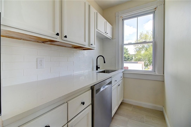 93 Naples Ave, Providence, RI 02908 - kitchen featuring dishwasher, a sink, decorative backsplash, baseboards, and light countertops