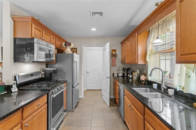 5 Leighas Ln, Coventry, RI 02816 - kitchen with appliances with stainless steel finishes, a sink, light tile patterned floors, brown cabinetry, and recessed lighting