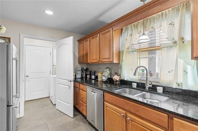 5 Leighas Ln, Coventry, RI 02816 - kitchen with stainless steel appliances, a sink, brown cabinets, light tile patterned floors, and dark stone countertops