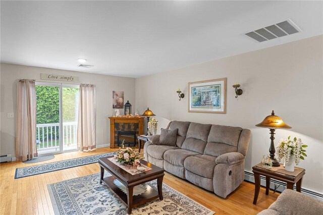 5 Leighas Ln, Coventry, RI 02816 - living room with light wood-type flooring, a fireplace, and a baseboard heating unit