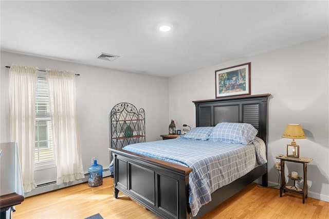 5 Leighas Ln, Coventry, RI 02816 - bedroom featuring light wood-style floors, multiple windows, a baseboard radiator, and baseboards