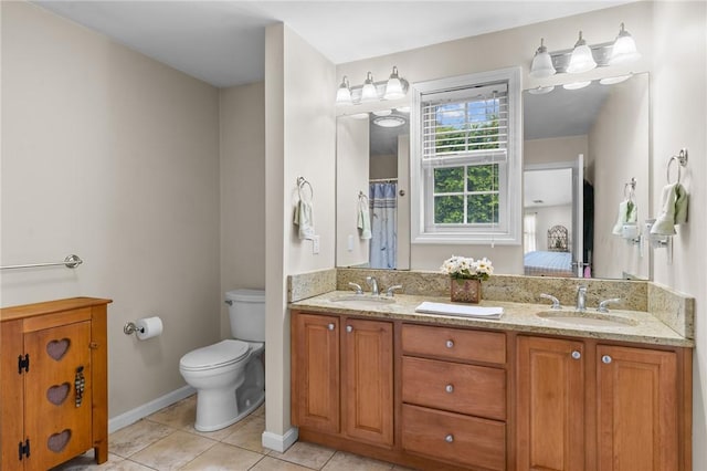 5 Leighas Ln, Coventry, RI 02816 - ensuite bathroom featuring double vanity, toilet, tile patterned floors, and baseboards
