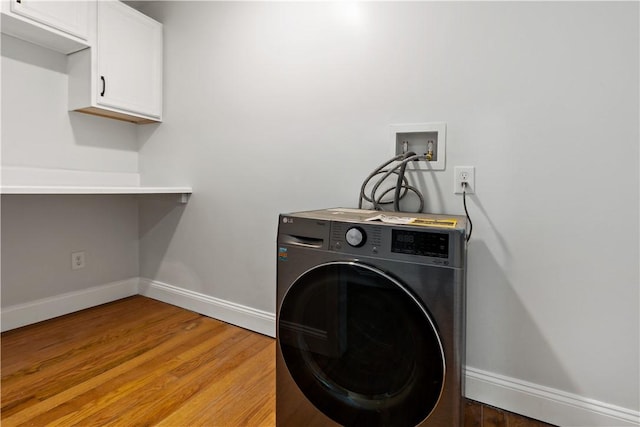 1300 Wallum Lake Rd, Burrillville, RI 02859 - laundry room with washer / dryer, cabinet space, baseboards, and light wood finished floors