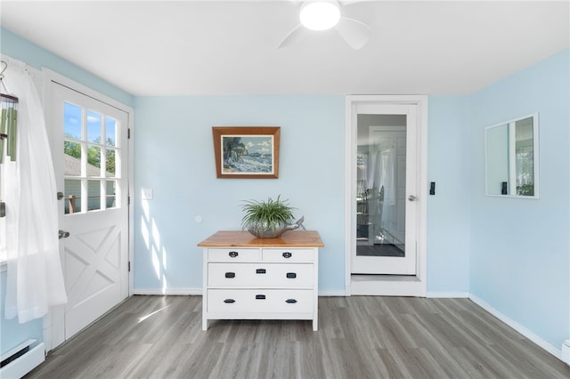 39 Camac St, Pawtucket, RI 02861 - foyer with a baseboard radiator, wood finished floors, baseboards, and ceiling fan