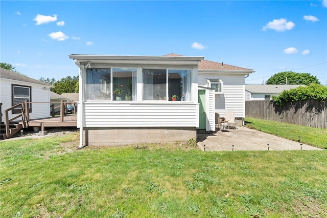39 Camac St, Pawtucket, RI 02861 - rear view of house featuring a wooden deck, a patio, a sunroom, and a shingled roof
