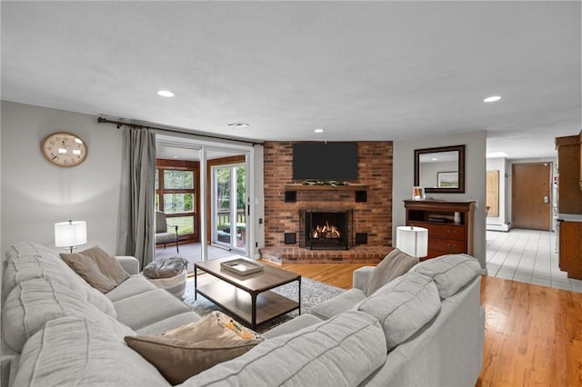 15 Womantam Ln, Cumberland, RI 02864 - living room with light wood-style floors, a brick fireplace, and recessed lighting