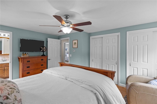 15 Womantam Ln, Cumberland, RI 02864 - bedroom featuring wood finished floors, ceiling fan, baseboards, ensuite bath, and a sink