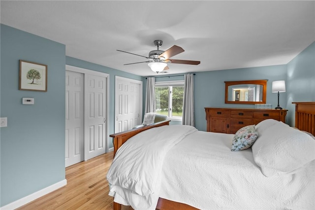 15 Womantam Ln, Cumberland, RI 02864 - bedroom with two closets, baseboards, light wood-type flooring, and ceiling fan
