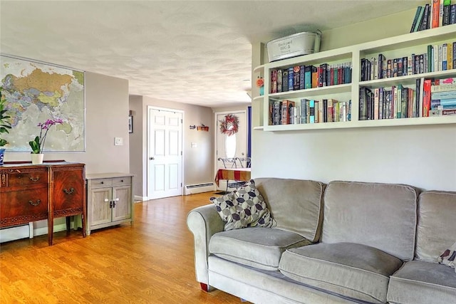 92 Chatworth Ave, Warwick, RI 02886 - living room featuring light wood-type flooring, a baseboard radiator, and a textured ceiling