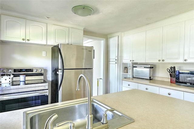 92 Chatworth Ave, Warwick, RI 02886 - kitchen with appliances with stainless steel finishes, a sink, white cabinetry, and light countertops