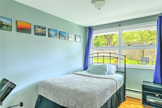 92 Chatworth Ave, Warwick, RI 02886 - bedroom featuring a baseboard heating unit and wood finished floors