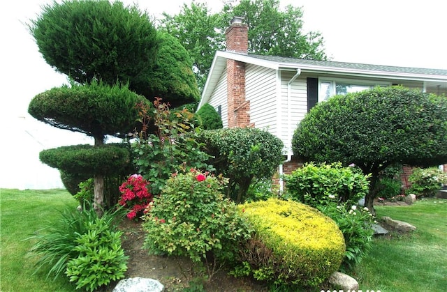 15 Ponderosa Dr, West Warwick, RI 02893 - view of home's exterior with a chimney and a yard
