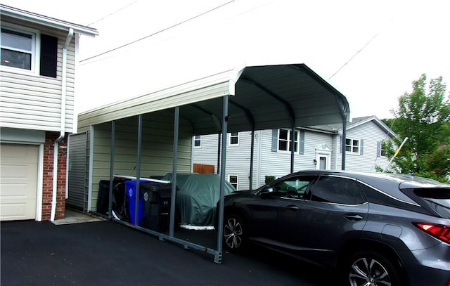 15 Ponderosa Dr, West Warwick, RI 02893 - view of vehicle parking featuring driveway and a detached carport