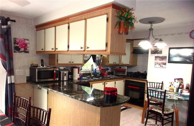 15 Ponderosa Dr, West Warwick, RI 02893 - kitchen with black oven, stainless steel microwave, a peninsula, a sink, and dark stone countertops