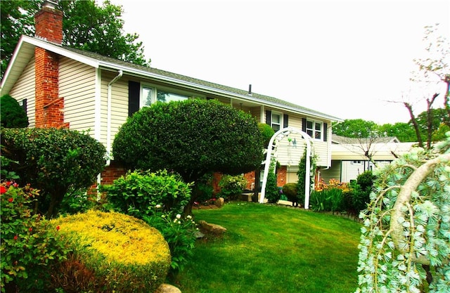 15 Ponderosa Dr, West Warwick, RI 02893 - view of front of home with a chimney and a front lawn