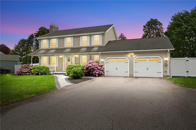 1710 Phenix Ave, Cranston, RI 02921 - colonial inspired home featuring a chimney, a garage, driveway, covered porch, and a gate