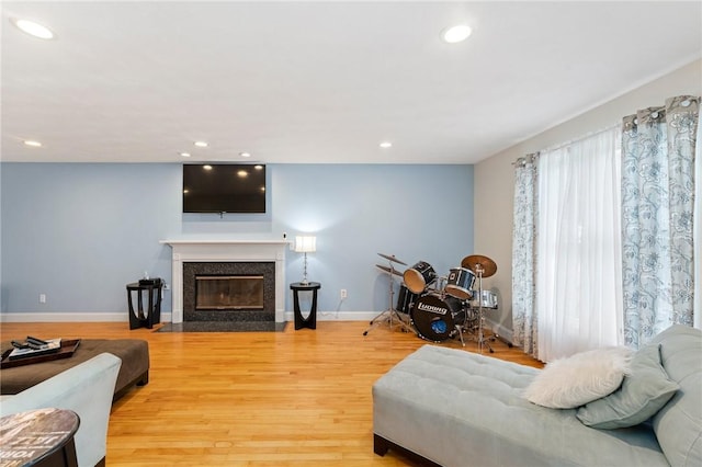 1710 Phenix Ave, Cranston, RI 02921 - living area featuring recessed lighting, light wood finished floors, a premium fireplace, and baseboards