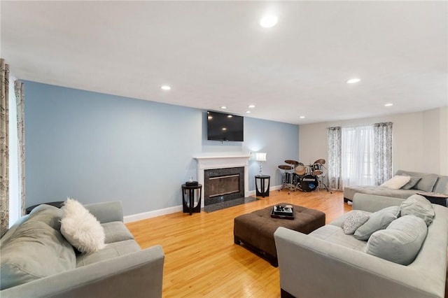 1710 Phenix Ave, Cranston, RI 02921 - living area with a fireplace, light wood-type flooring, recessed lighting, and baseboards