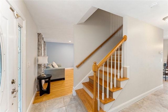 1710 Phenix Ave, Cranston, RI 02921 - entryway featuring baseboards, tile patterned flooring, and stairs
