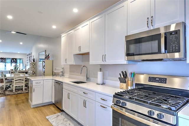 77 W Valley Cir Unit 77, West Warwick, RI 02893 - kitchen featuring appliances with stainless steel finishes, a sink, white cabinets, light countertops, and recessed lighting