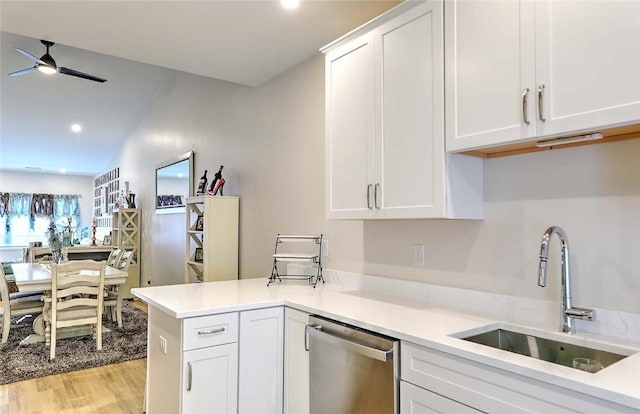 77 W Valley Cir Unit 77, West Warwick, RI 02893 - kitchen with stainless steel dishwasher, a sink, a ceiling fan, light wood-type flooring, and white cabinetry