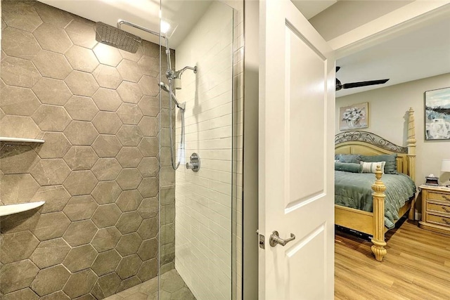 77 W Valley Cir Unit 77, West Warwick, RI 02893 - ensuite bathroom featuring tiled shower, wood finished floors, and ceiling fan