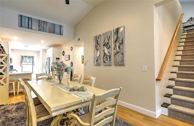 77 W Valley Cir Unit 77, West Warwick, RI 02893 - dining room with stairway, light wood-style floors, baseboards, and lofted ceiling