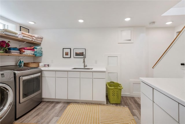 7 Maloney Ln, Middletown, RI 02842 - laundry room featuring washer and dryer, light wood-style flooring, cabinet space, and recessed lighting