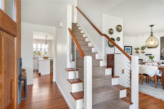 7 Maloney Ln, Middletown, RI 02842 - staircase featuring wood finished floors and a chandelier